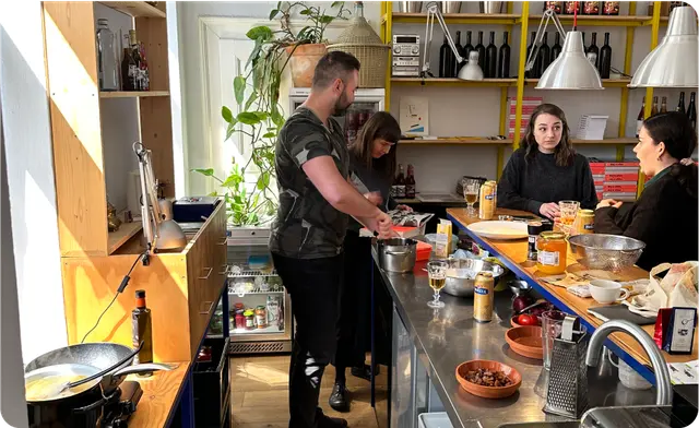 The team cooking dinner together in a kitchen