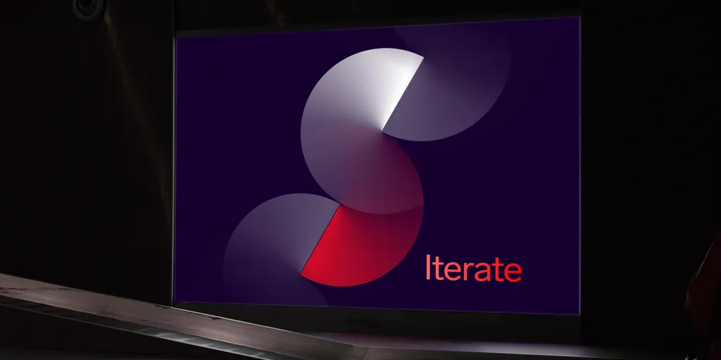 Sudolabs' new S mark with the word “Iterate”, projected on a screen in a dark room