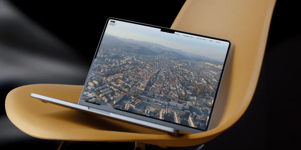The new UHA Košice website on a laptop, opening on an aerial view of Košice