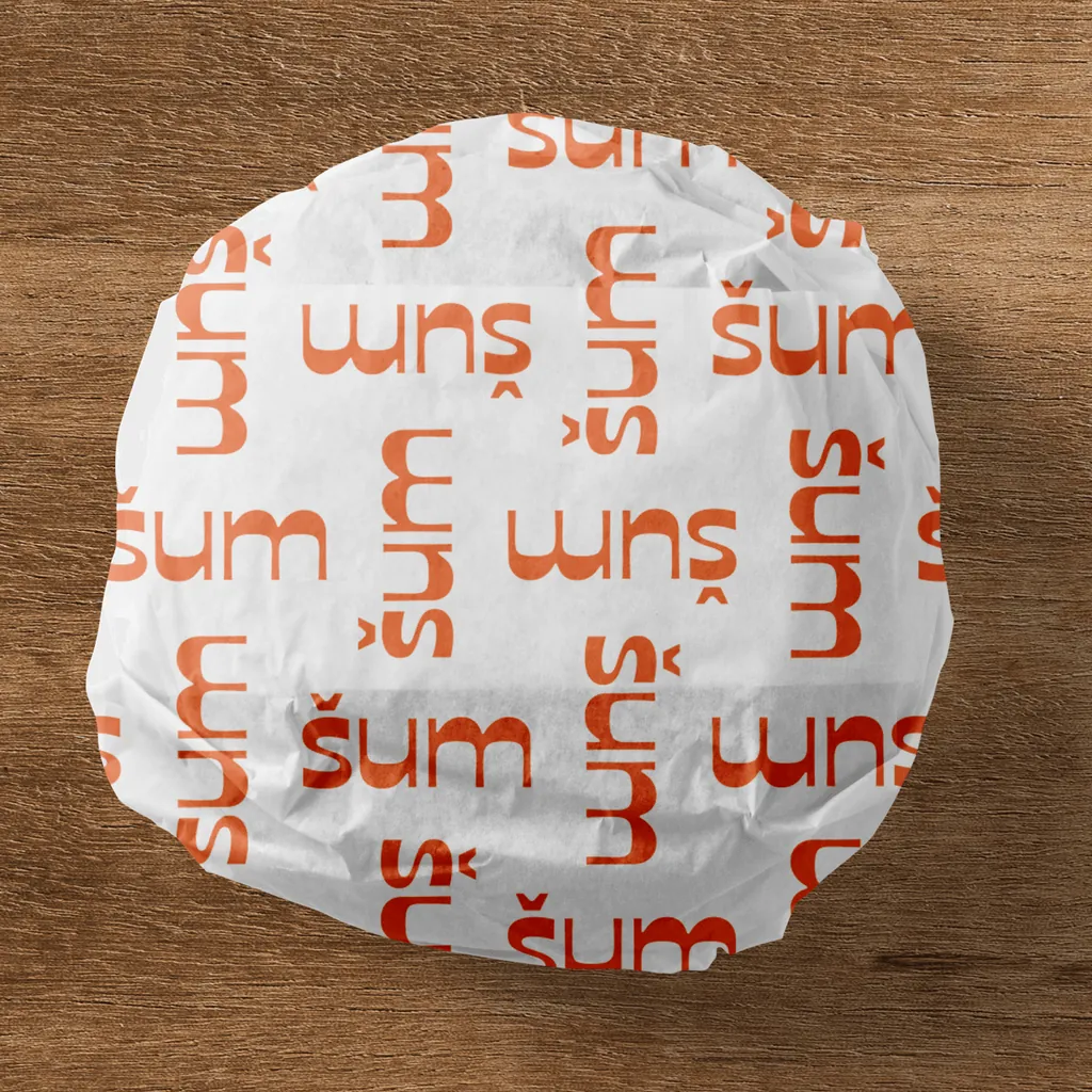 šum wrapping paper with the repeated logo, folded around a round package