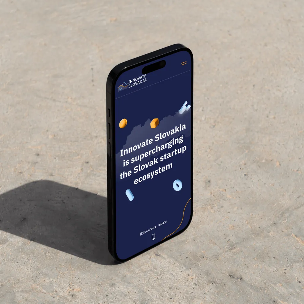 The Innovate Slovakia mobile homepage, “Innovate Slovakia is supercharging the Slovak startup ecosystem”, on a phone standing on concrete